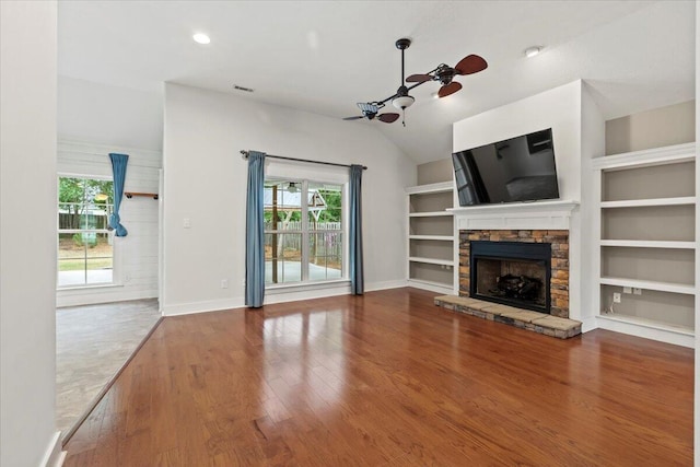 459 Sebastian Dr, Grovetown, GA 30813 - unfurnished living room with a fireplace, wood finished floors, vaulted ceiling, built in shelves, and a ceiling fan