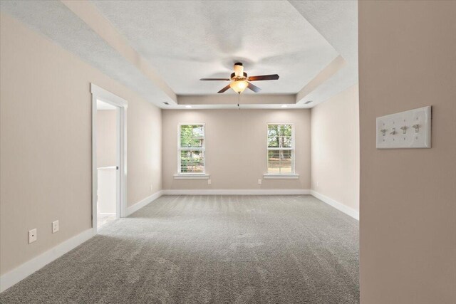 459 Sebastian Dr, Grovetown, GA 30813 - empty room featuring a raised ceiling, carpet, ceiling fan, and a textured ceiling