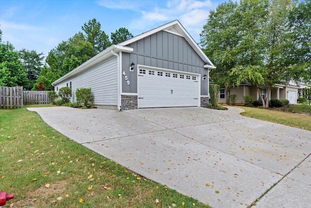 459 Sebastian Dr, Grovetown, GA 30813 - view of home's exterior featuring board and batten siding, stone siding, concrete driveway, and a garage