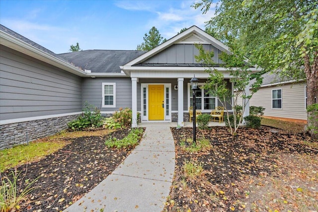 459 Sebastian Dr, Grovetown, GA 30813 - view of front of house with board and batten siding, a porch, and stone siding