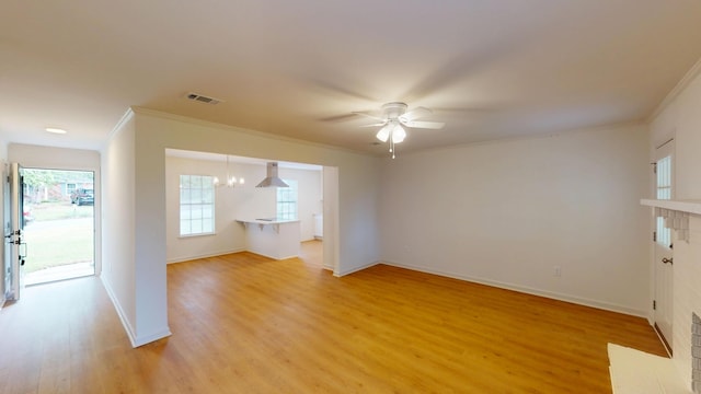 unfurnished living room featuring visible vents, light wood-style floors, and crown molding