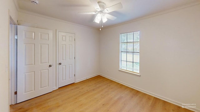 unfurnished bedroom featuring ornamental molding, ceiling fan, light wood finished floors, and baseboards