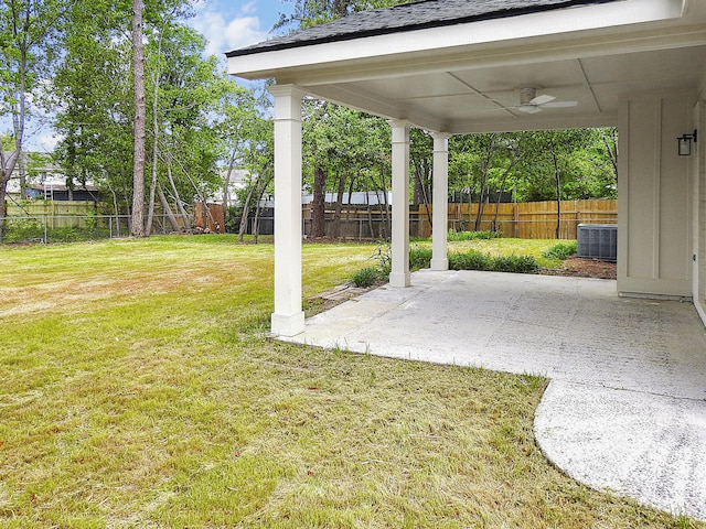 view of yard featuring cooling unit, a ceiling fan, a patio, and a fenced backyard