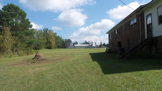 view of yard featuring central air condition unit