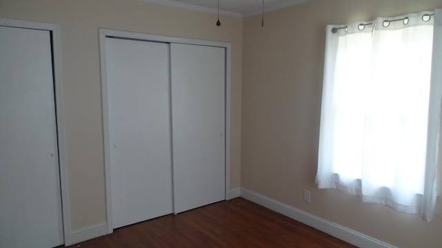 unfurnished bedroom featuring dark hardwood / wood-style floors and a closet