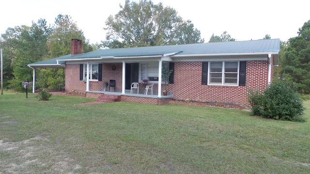 ranch-style home featuring a porch and a front lawn