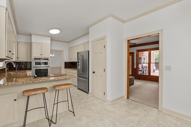 4119 N Knollcrest Cir, Martinez, GA 30907 - kitchen featuring appliances with stainless steel finishes, a sink, crown molding, a peninsula, and tasteful backsplash