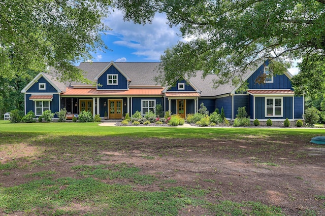2550 Otts Ln, Harlem, GA 30814 - view of front of house with french doors, a standing seam roof, a front yard, and board and batten siding