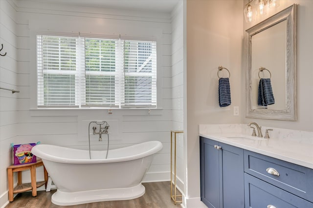 2550 Otts Ln, Harlem, GA 30814 - full bath featuring wood finished floors, healthy amount of natural light, vanity, and a soaking tub