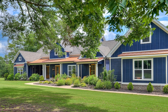 2550 Otts Ln, Harlem, GA 30814 - view of front of property with board and batten siding, a standing seam roof, a front yard, and a metal roof