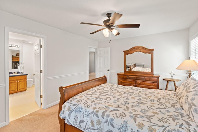 222 Canterbury Dr, Wrens, GA 30833 - bedroom with light colored carpet, connected bathroom, and ceiling fan