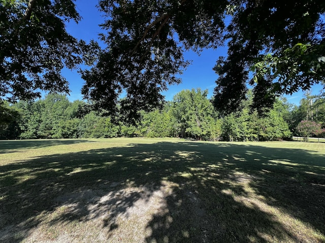 2786 Tudor Rd, Dearing, GA 30808 - view of grassy yard featuring a forest view