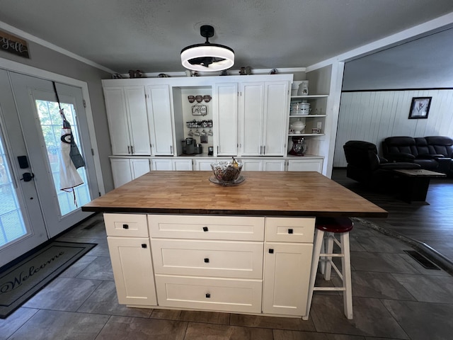 2786 Tudor Rd, Dearing, GA 30808 - kitchen featuring wood counters, open shelves, plenty of natural light, crown molding, and white cabinetry