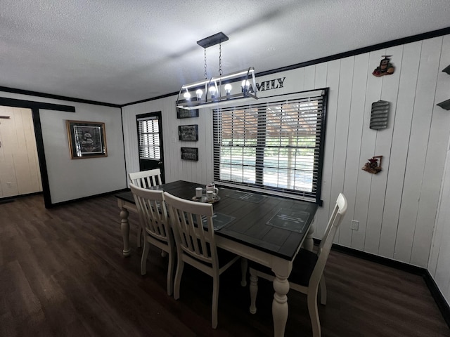 2786 Tudor Rd, Dearing, GA 30808 - dining room with a chandelier, wood finished floors, a textured ceiling, and crown molding