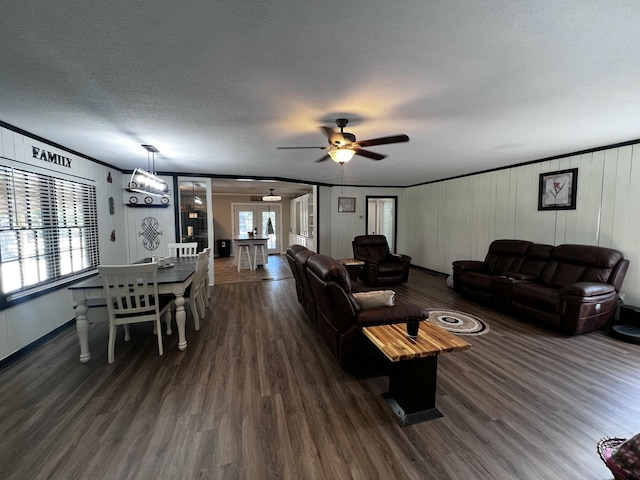 2786 Tudor Rd, Dearing, GA 30808 - living room with dark wood-type flooring, crown molding, a ceiling fan, a textured ceiling, and a decorative wall