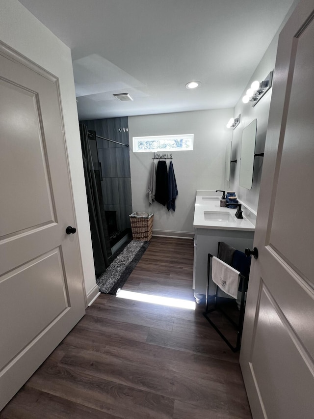 2786 Tudor Rd, Dearing, GA 30808 - full bath with vanity, tiled shower, recessed lighting, and wood finished floors