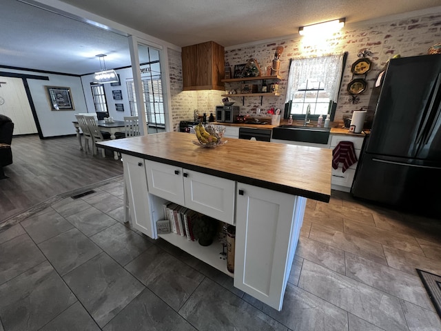 2786 Tudor Rd, Dearing, GA 30808 - kitchen with wood counters, black appliances, white cabinetry, and a kitchen island