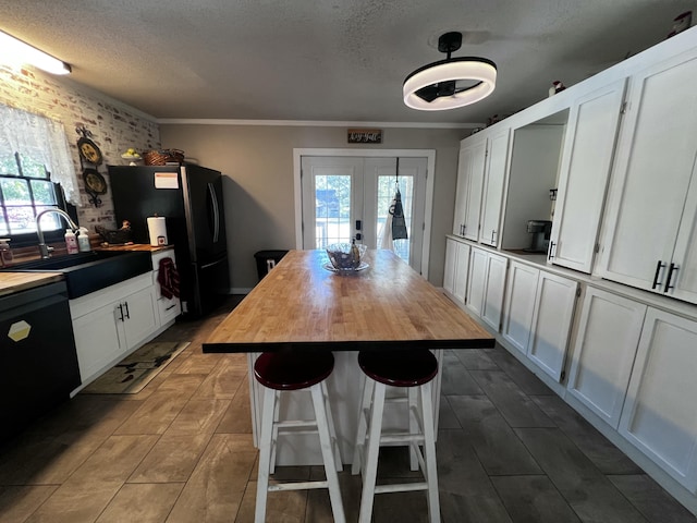 2786 Tudor Rd, Dearing, GA 30808 - kitchen with wooden counters, freestanding refrigerator, french doors, plenty of natural light, and a textured ceiling