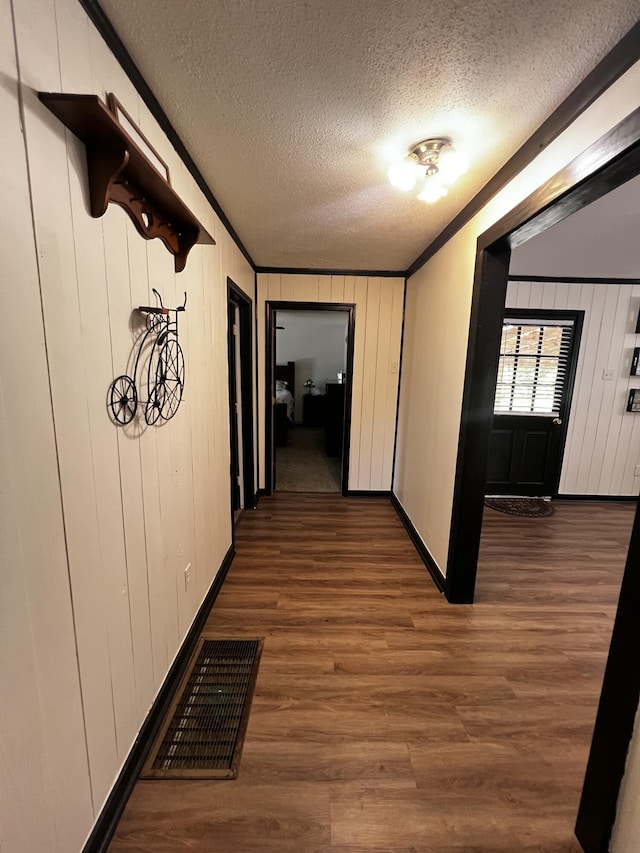 2786 Tudor Rd, Dearing, GA 30808 - hallway featuring crown molding, wood finished floors, and a textured ceiling