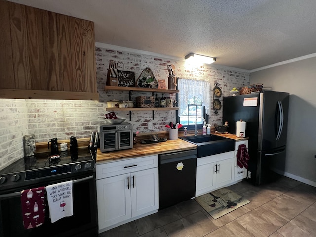 2786 Tudor Rd, Dearing, GA 30808 - kitchen featuring black dishwasher, electric range, butcher block countertops, freestanding refrigerator, and a textured ceiling