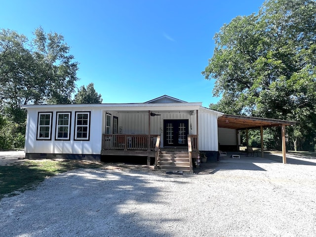 2786 Tudor Rd, Dearing, GA 30808 - manufactured / mobile home featuring crawl space, an attached carport, french doors, driveway, and a porch