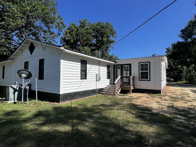 2786 Tudor Rd, Dearing, GA 30808 - view of front of property featuring board and batten siding, a front yard, and french doors