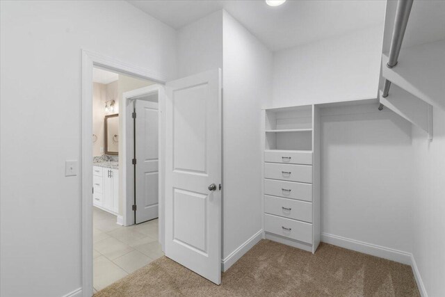 spacious closet with dark carpet