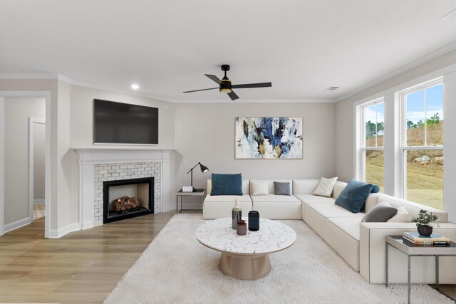 unfurnished living room with a tiled fireplace, ceiling fan, dark hardwood / wood-style flooring, and a healthy amount of sunlight