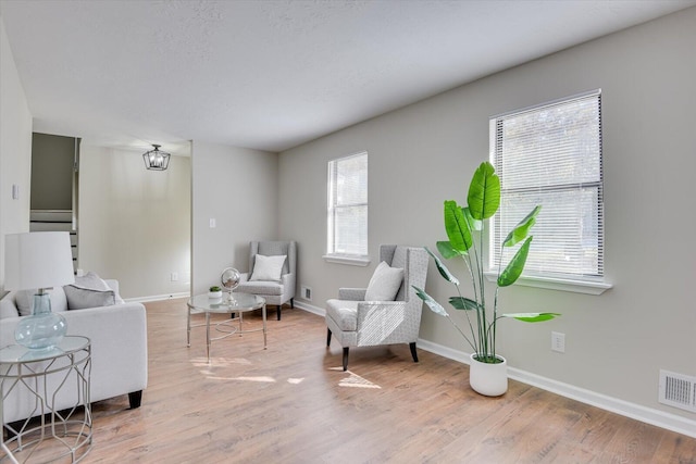 living area featuring plenty of natural light and hardwood / wood-style floors