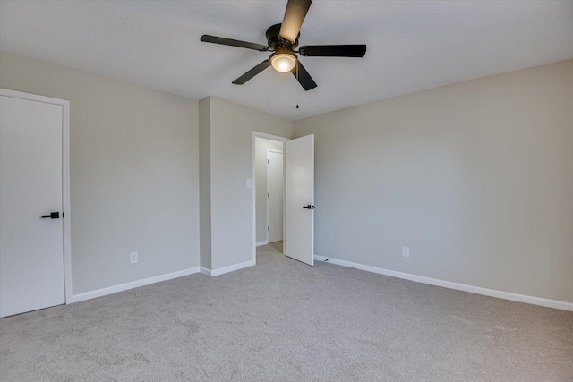 unfurnished room featuring ceiling fan and light carpet