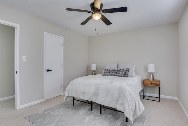 bedroom with ceiling fan and light colored carpet