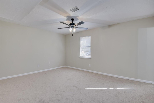 spare room with carpet flooring, ceiling fan, and a textured ceiling