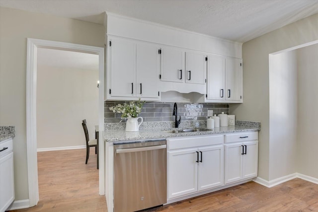 kitchen featuring white cabinets, dishwasher, sink, and light hardwood / wood-style flooring