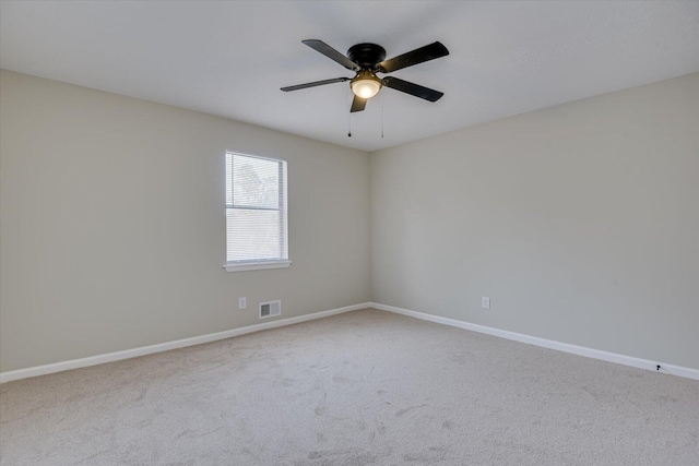 empty room featuring carpet flooring and ceiling fan