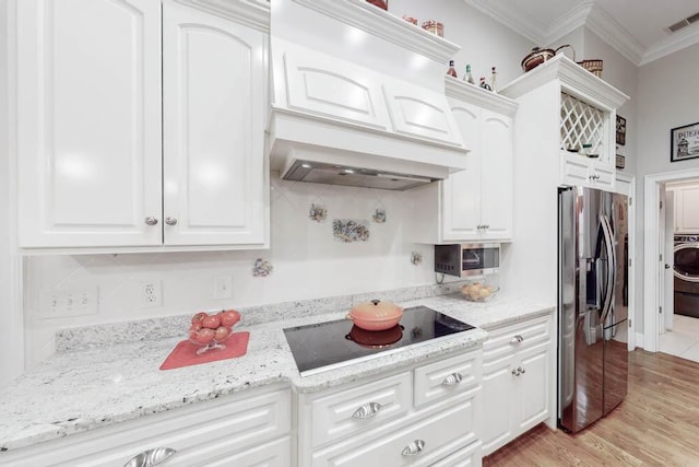 kitchen with white cabinets, stainless steel fridge with ice dispenser, ornamental molding, and black electric cooktop