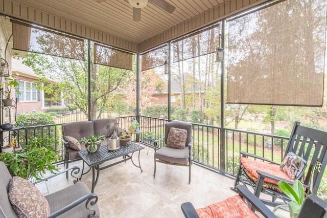 sunroom / solarium featuring ceiling fan