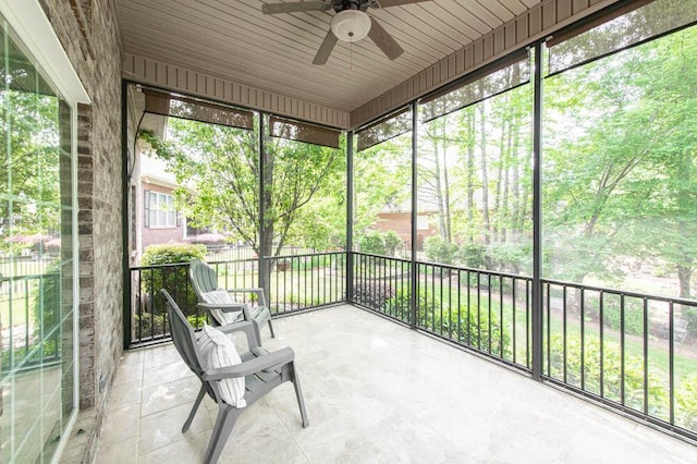 unfurnished sunroom with a ceiling fan