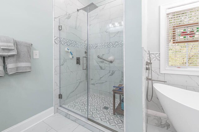 bathroom featuring shower with separate bathtub