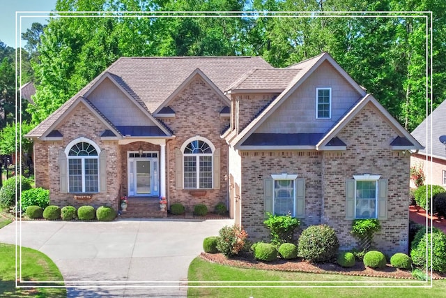 craftsman-style home with brick siding