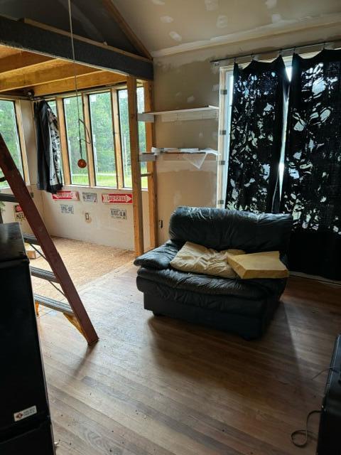 sitting room featuring hardwood / wood-style floors and vaulted ceiling