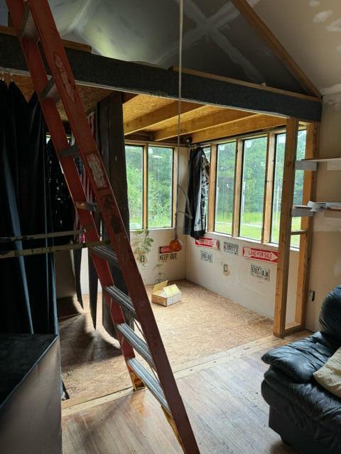 interior space with hardwood / wood-style flooring and lofted ceiling