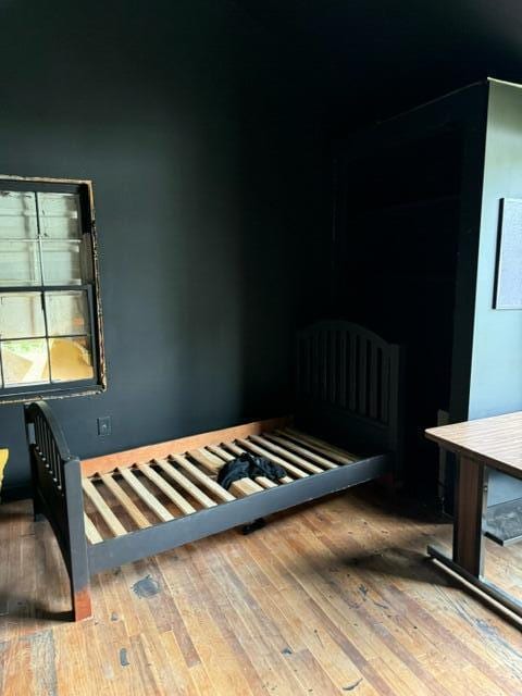 bedroom with hardwood / wood-style flooring