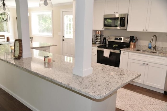505 Ridgeland Dr, Sandersville, GA 31082 - kitchen with appliances with stainless steel finishes, white cabinetry, light stone counters, and dark wood-style flooring