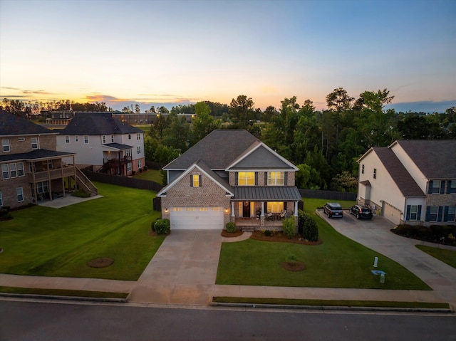 1206 Arcilla Pt, Martinez, GA 30907 - view of front of property with a porch, concrete driveway, a standing seam roof, brick siding, and metal roof