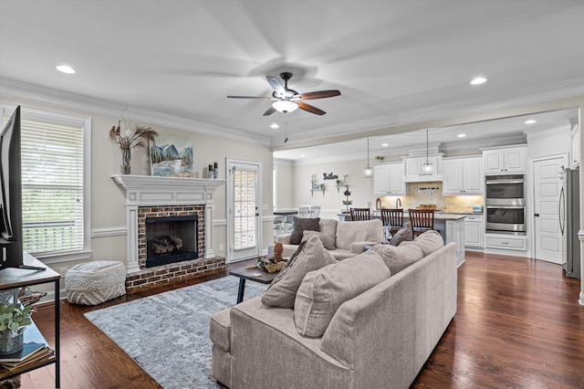 1206 Arcilla Pt, Martinez, GA 30907 - living room featuring a ceiling fan, plenty of natural light, crown molding, dark wood-type flooring, and a brick fireplace