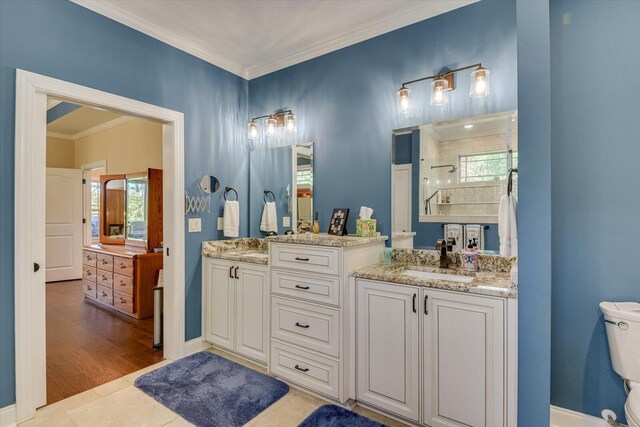 bathroom with vanity, crown molding, a shower, and hardwood / wood-style flooring