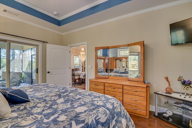 bedroom with hardwood / wood-style flooring, access to exterior, and crown molding