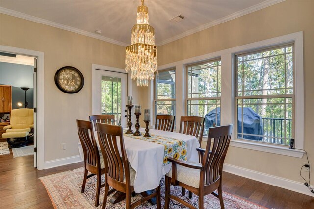 dining area with a healthy amount of sunlight, crown molding, and dark wood-type flooring