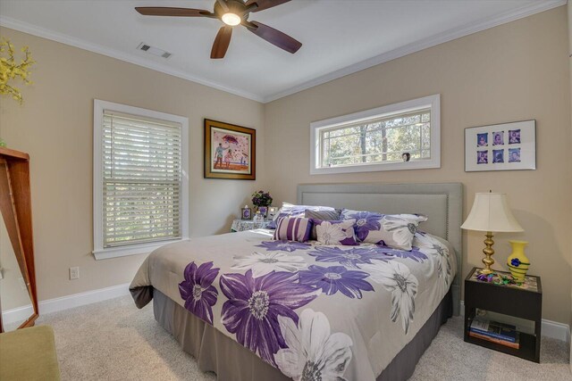 carpeted bedroom featuring ceiling fan and ornamental molding