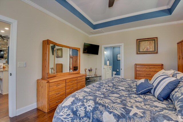 bedroom with a tray ceiling, ceiling fan, ornamental molding, and hardwood / wood-style flooring